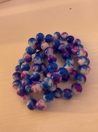 a blue and white beaded bracelet on a table