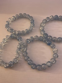 a set of blue glass beads on a white surface