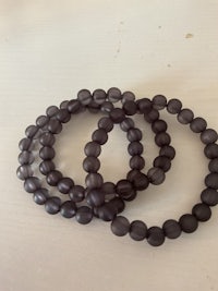 a pair of black beaded bracelets on a table