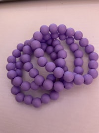 a bunch of purple beads stacked on top of each other