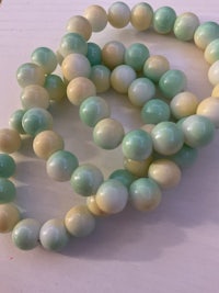 green and yellow jade beads on a table